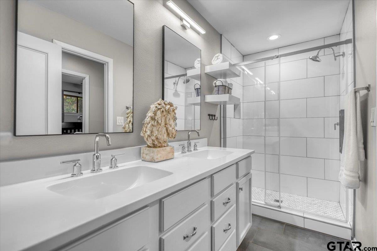 441 Hideaway Lane Hideaway, TX 75771 - Photo 23 of 38 a bathroom with a double vanity sink mirror and shower