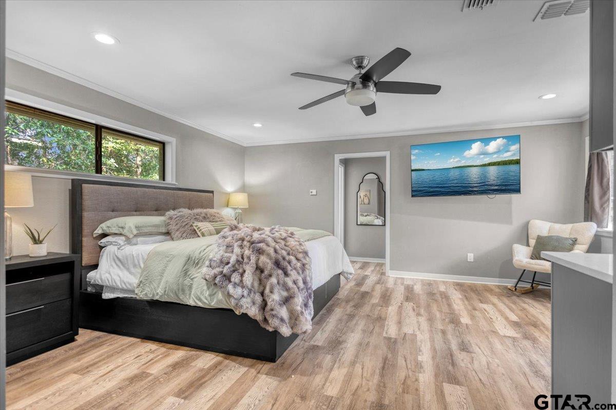 441 Hideaway Lane Hideaway, TX 75771 - Photo 24 of 38 a bedroom with a large bed and a chandelier