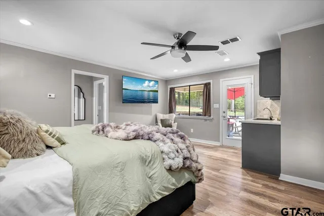 a bedroom with a large bed and flat screen tv