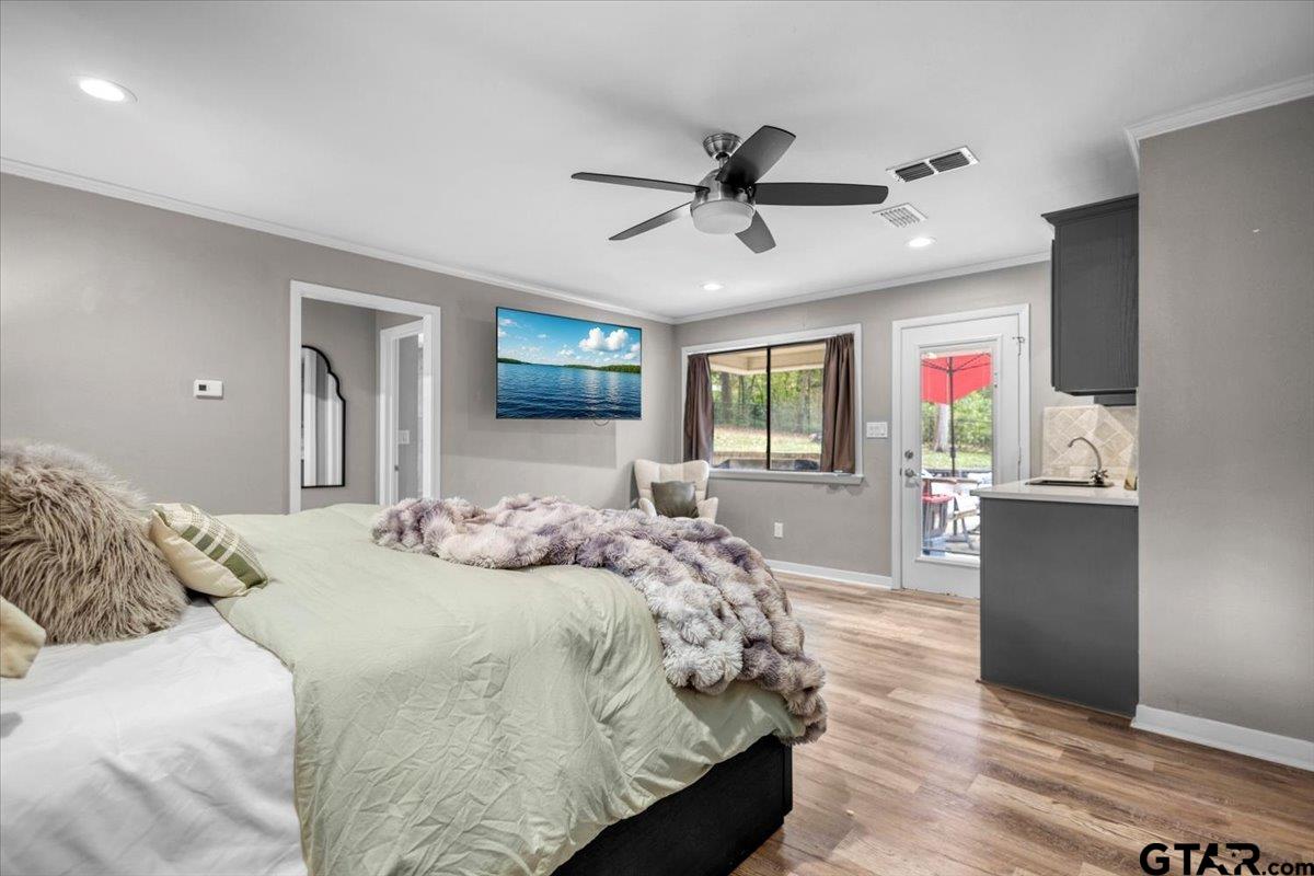 441 Hideaway Lane Hideaway, TX 75771 - Photo 27 of 38 a bedroom with a large bed and flat screen tv