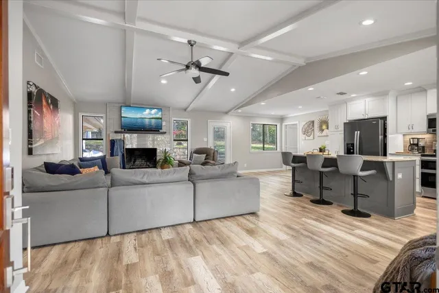 a living room with furniture a fireplace and a flat screen tv