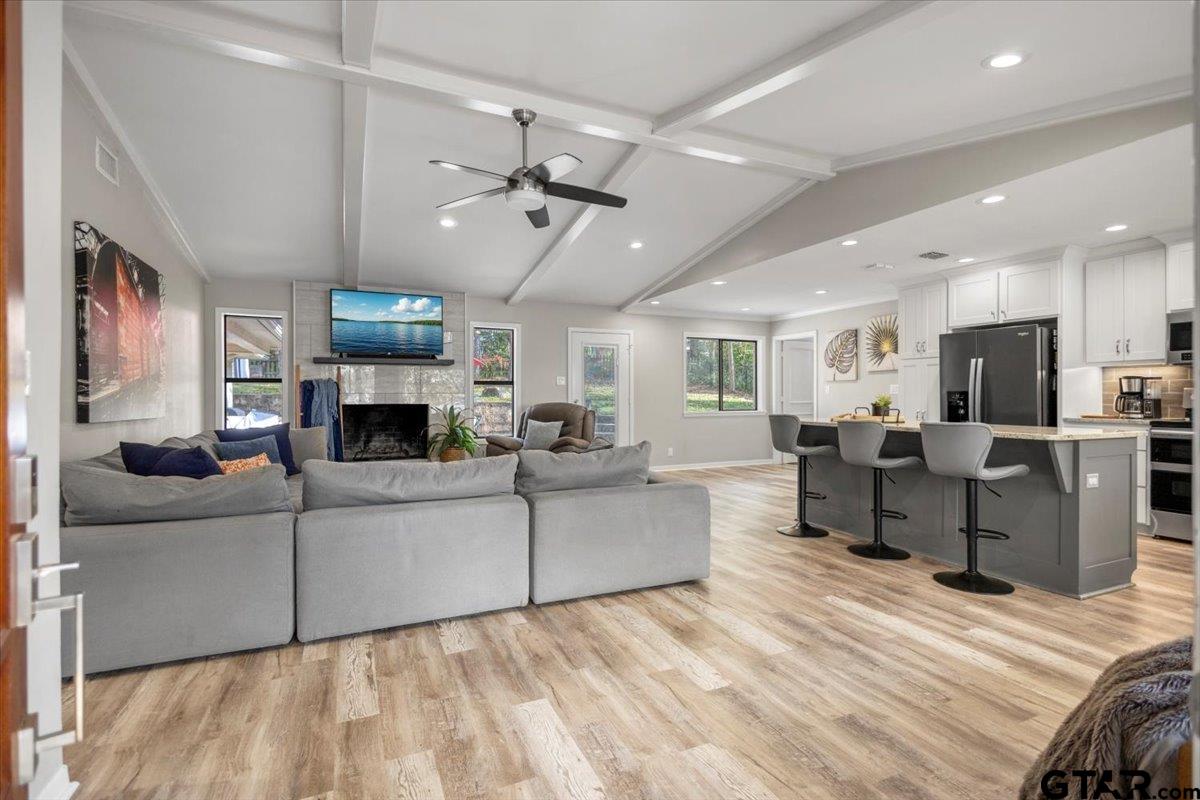 441 Hideaway Lane Hideaway, TX 75771 - Photo 4 of 38 a living room with furniture a fireplace and a flat screen tv