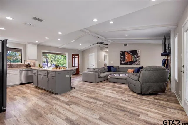 a living room with furniture and a wooden floor