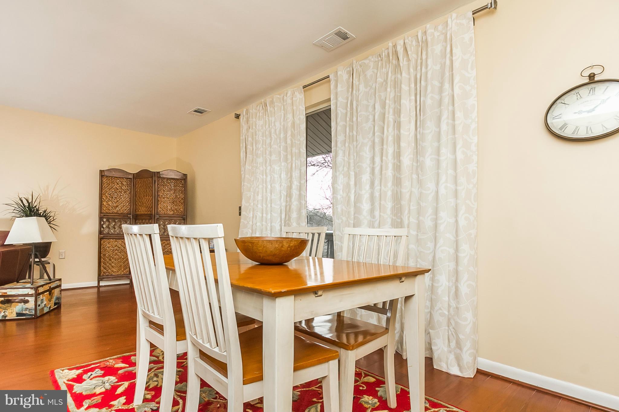 119 Cross Keys Road, Unit R119E Baltimore, MD 21210 - Photo 13 of 22 a view of a dining room with furniture and a table