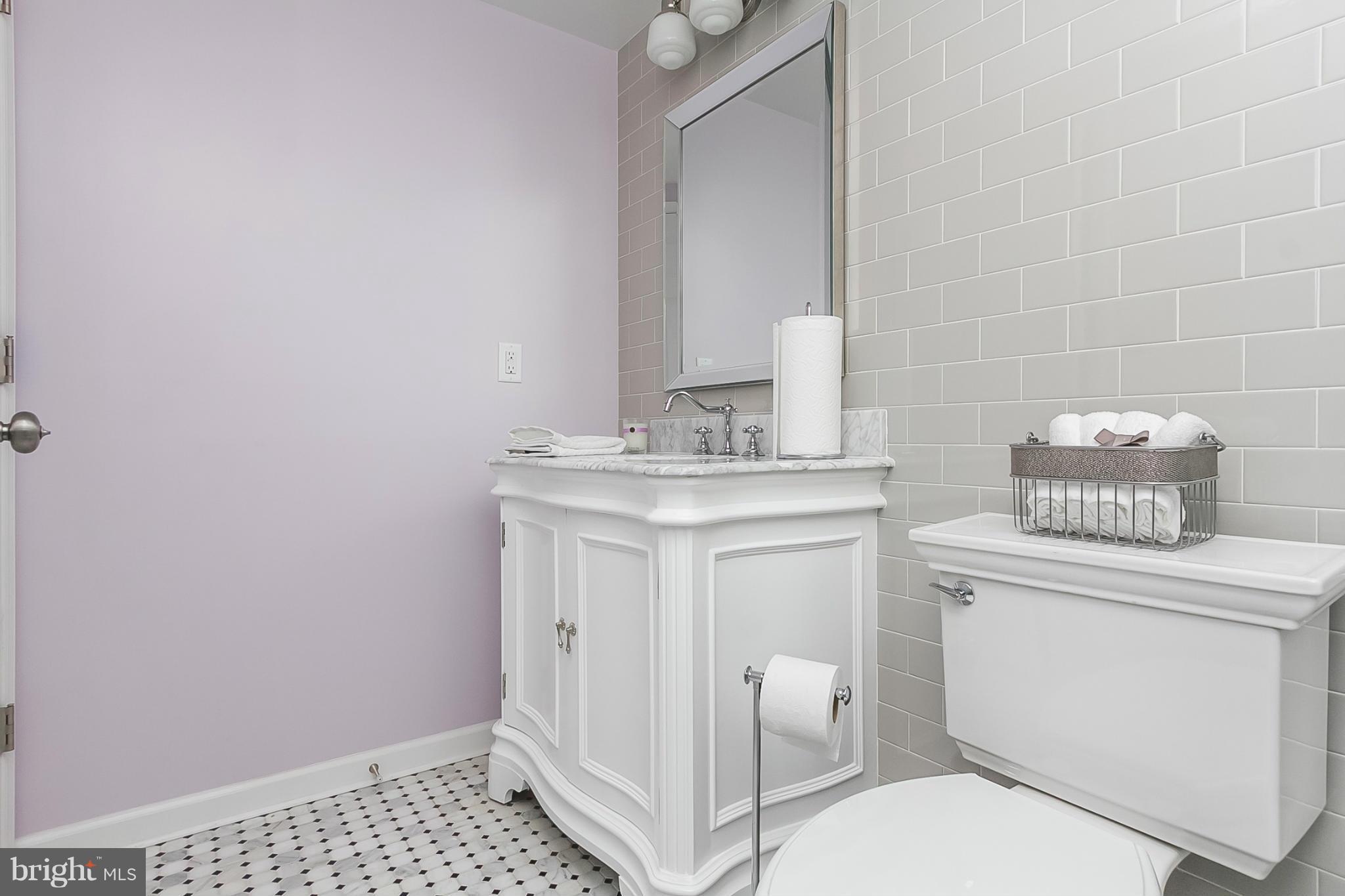 119 Cross Keys Road, Unit R119E Baltimore, MD 21210 - Photo 16 of 22 a bathroom with a sink toilet and a mirror