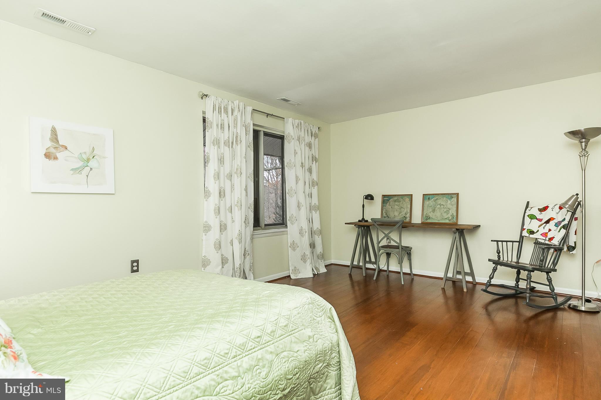 119 Cross Keys Road, Unit R119E Baltimore, MD 21210 - Photo 19 of 22 a spacious bedroom with a bed and a view of kitchen