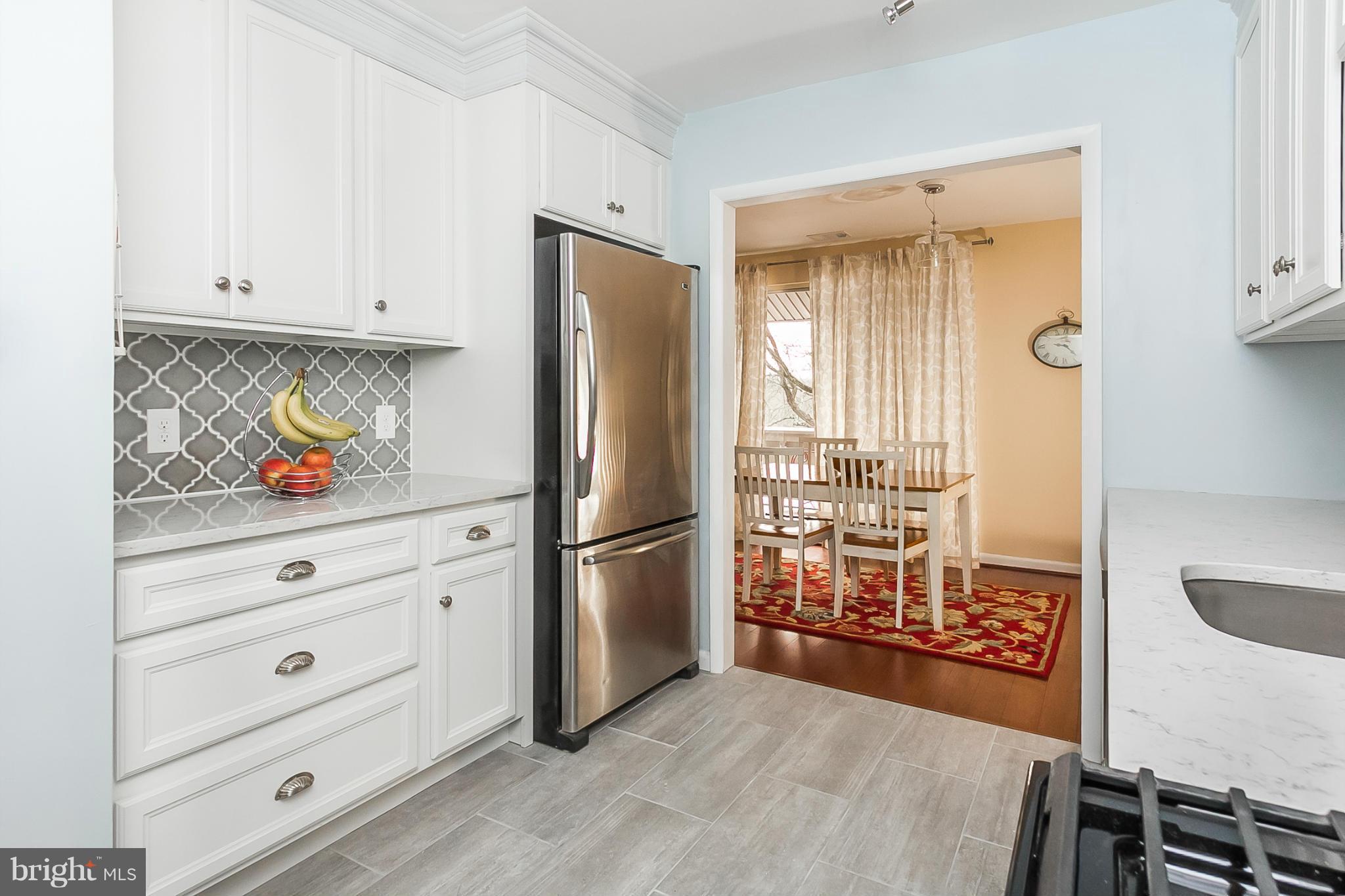 119 Cross Keys Road, Unit R119E Baltimore, MD 21210 - Photo 4 of 22 a kitchen with stainless steel appliances a refrigerator and a stove top oven