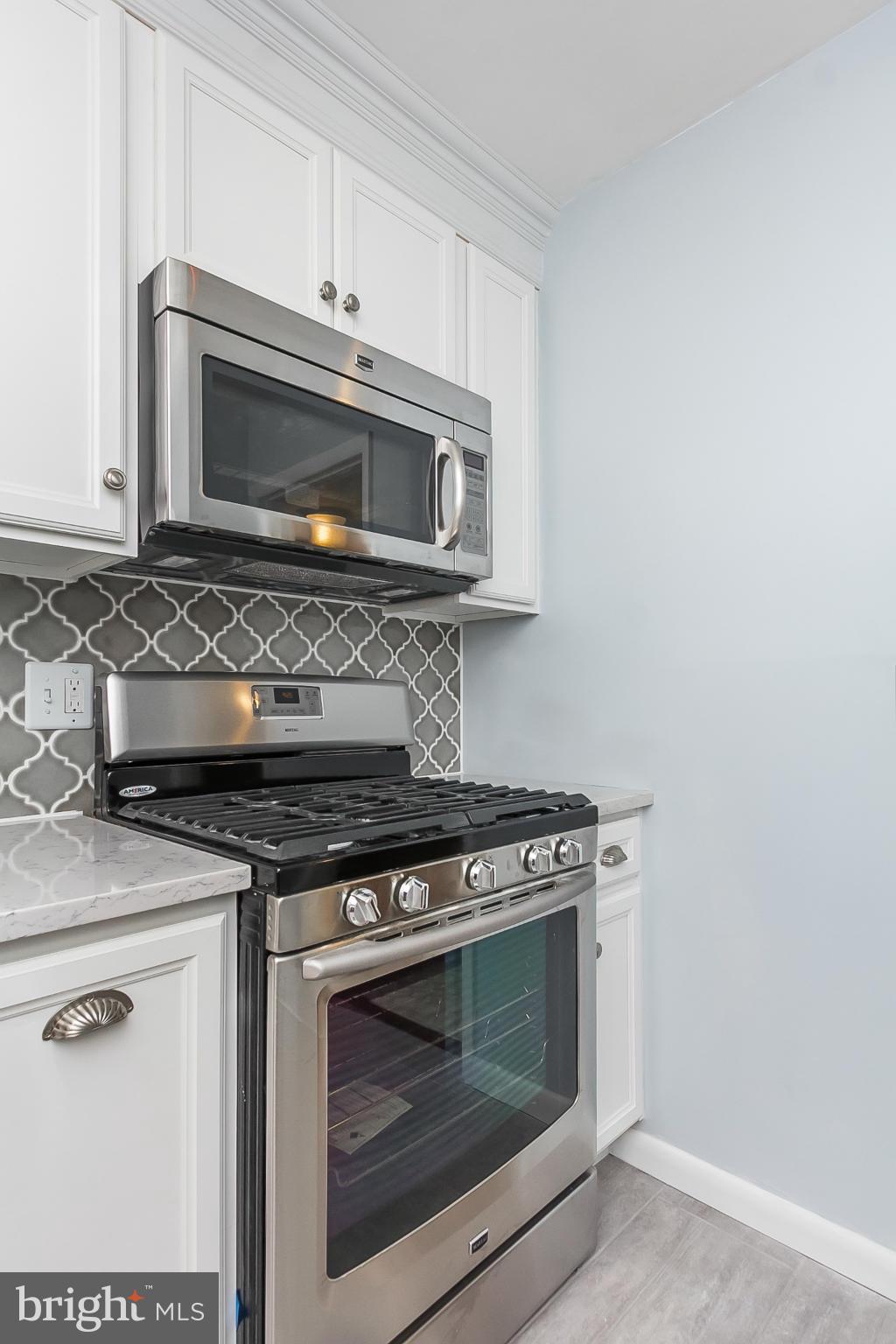 119 Cross Keys Road, Unit R119E Baltimore, MD 21210 - Photo 6 of 22 a stove top oven sitting inside of a kitchen