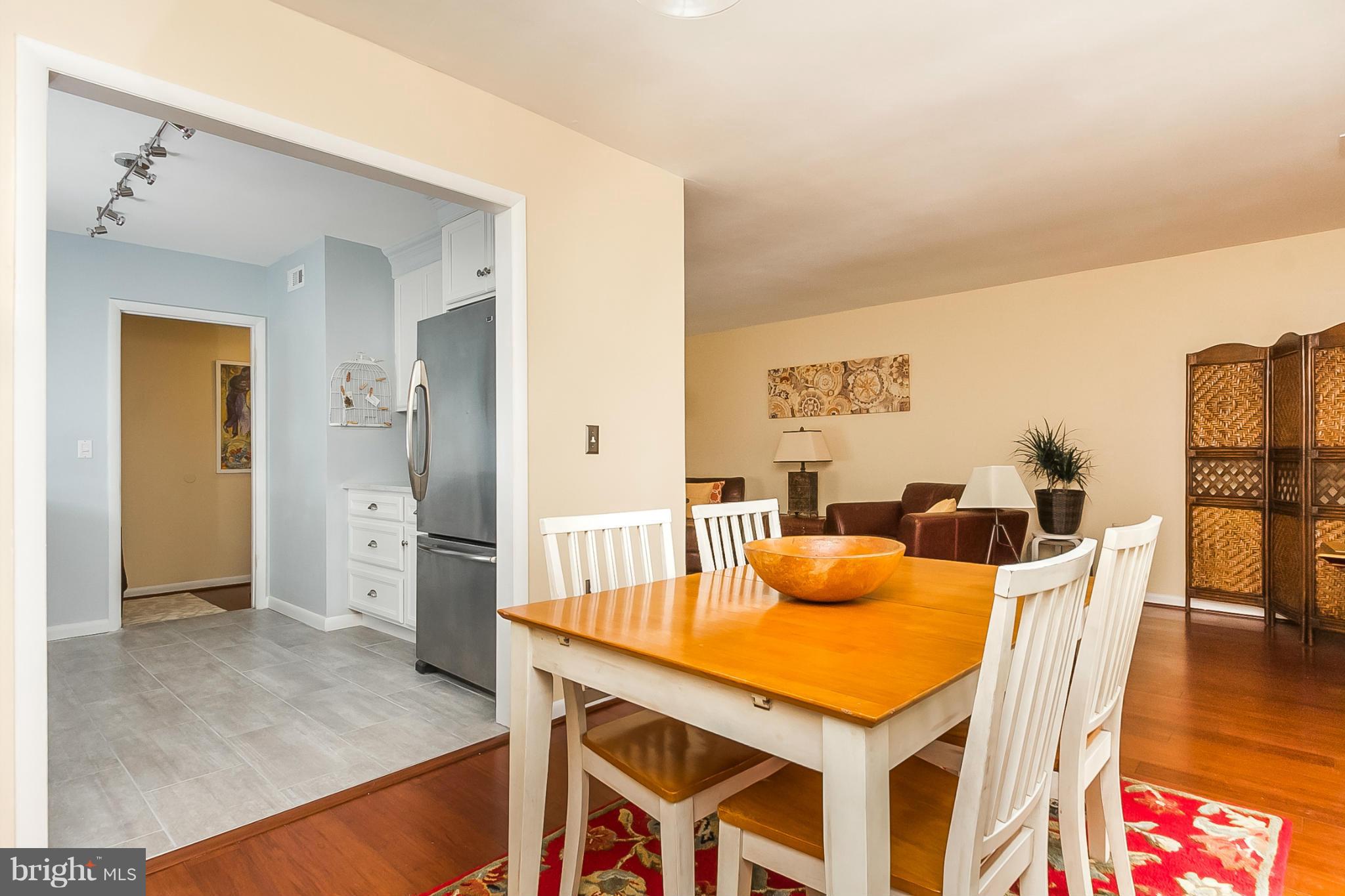 119 Cross Keys Road, Unit R119E Baltimore, MD 21210 - Photo 7 of 22 a dining room with furniture and wooden floor
