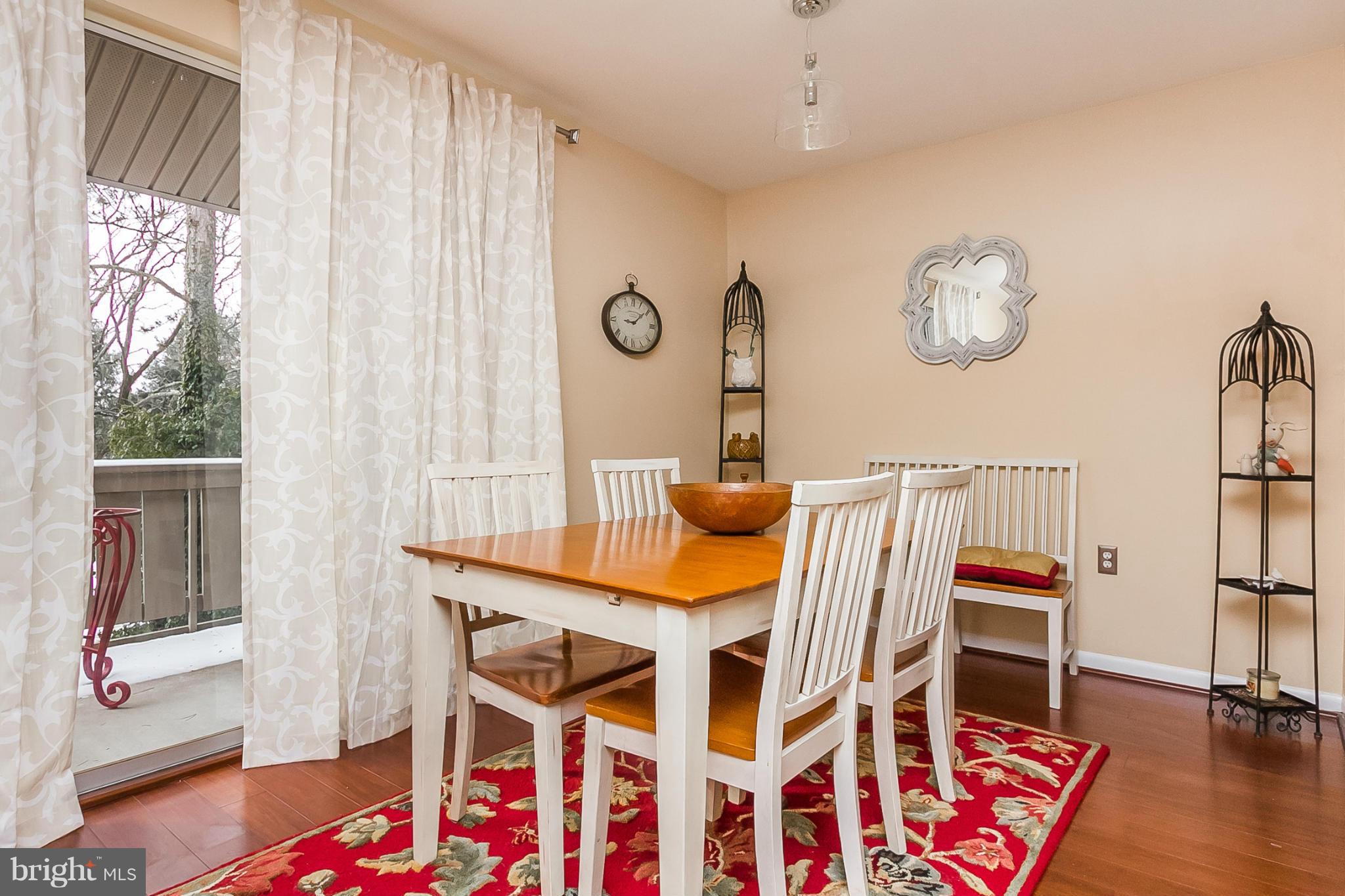 119 Cross Keys Road, Unit R119E Baltimore, MD 21210 - Photo 8 of 22 a view of a dining room with furniture and a window