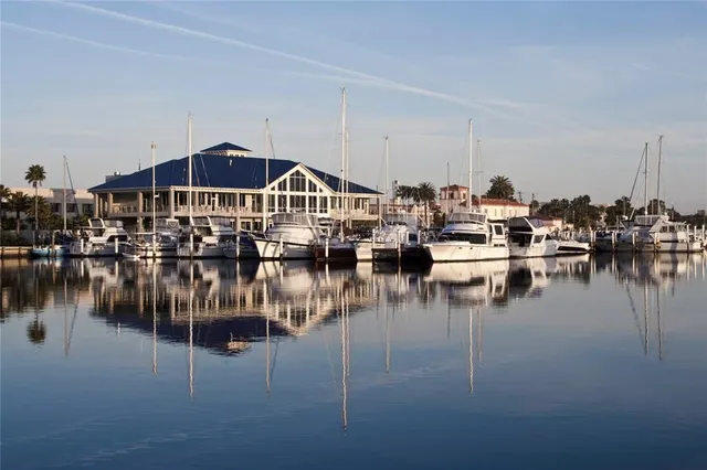 a view of a lake with boats and trees in the background