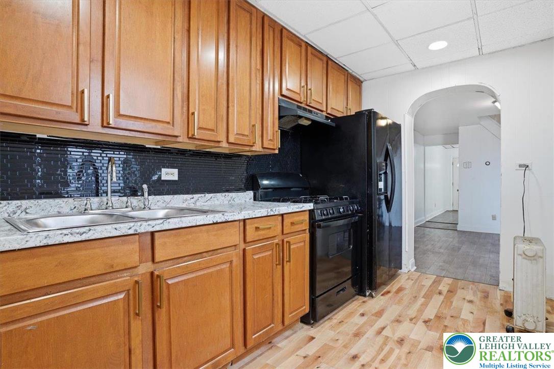 1171 Mechanic Street Bethlehem, PA 18015 - Photo 6 of 25 a kitchen with stainless steel appliances granite countertop a refrigerator sink and cabinets