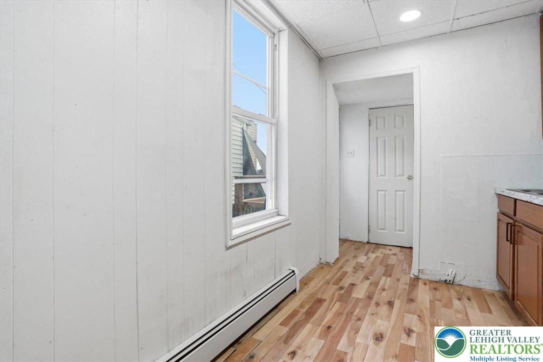 1171 Mechanic Street Bethlehem, PA 18015 - Photo 7 of 25 a view of a hallway with wooden floor and a bathroom
