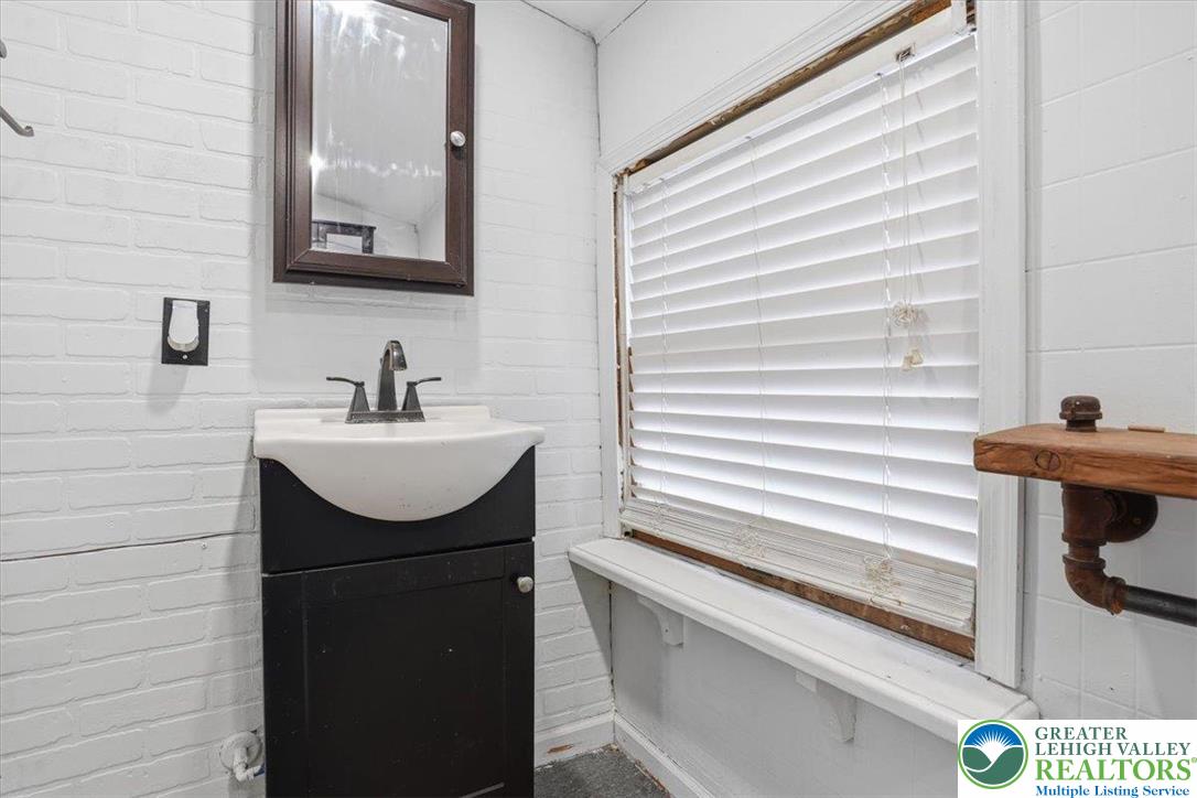 1171 Mechanic Street Bethlehem, PA 18015 - Photo 8 of 25 a bathroom with a sink and a mirror