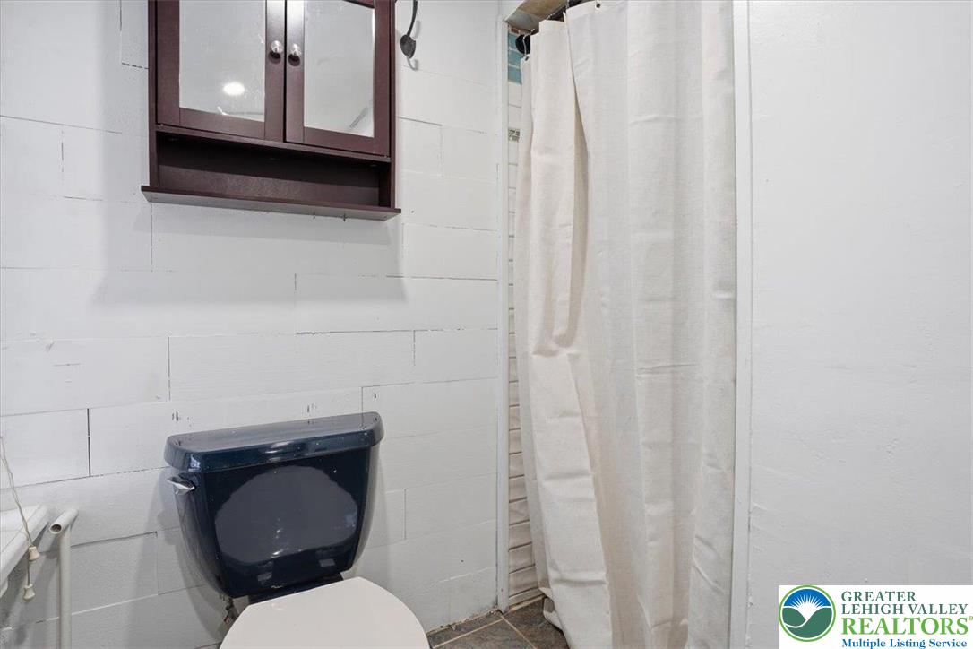 1171 Mechanic Street Bethlehem, PA 18015 - Photo 9 of 25 a bathroom with a toilet a sink and mirror