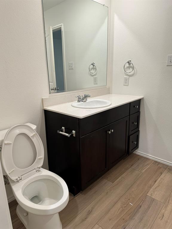 5906 Nyquist Way Forney, TX 75126 - Photo 22 of 27 Bathroom with wood finished floors, vanity, and a textured wall