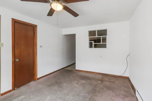 a view of a livingroom with a ceiling fan and window