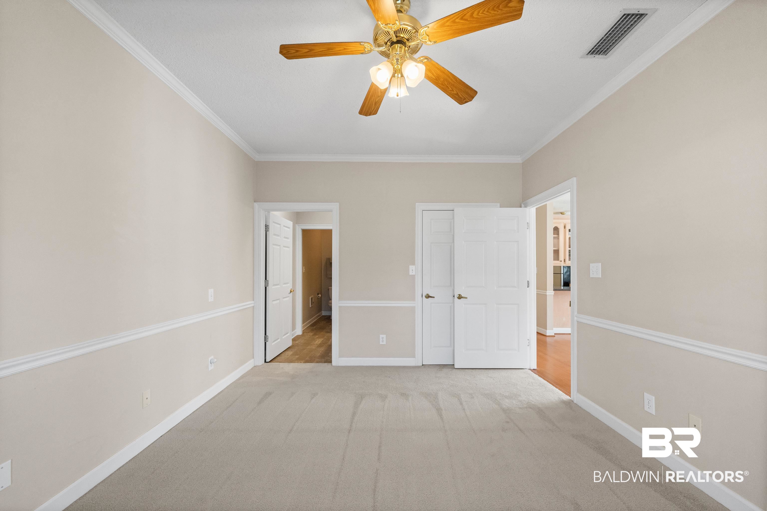 27 Cottage Drive Fairhope, AL 36532 - Photo 17 of 33 Unfurnished bedroom with crown molding, ceiling fan, and carpet floors