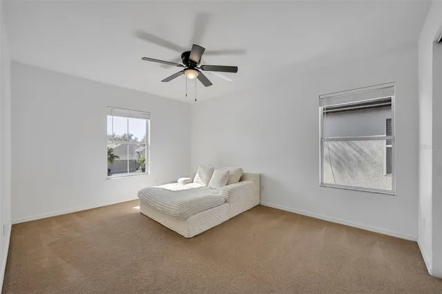 a spacious bedroom with a bed and a window