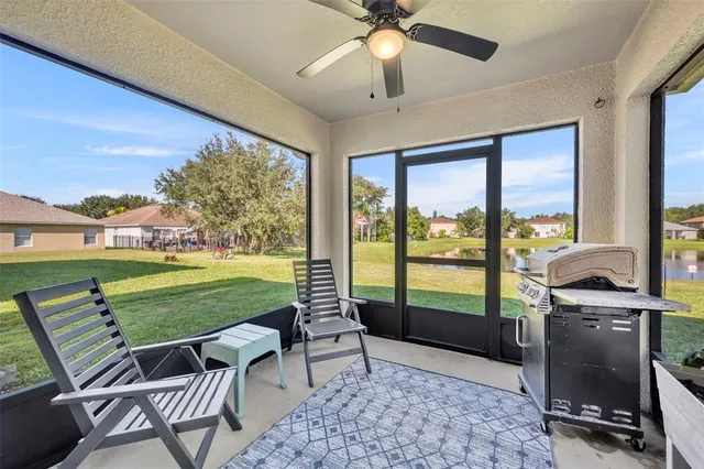 a living room with a floor to ceiling window and a table