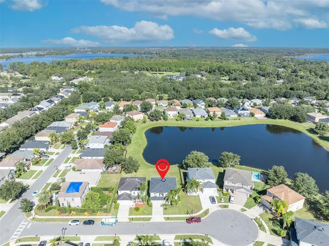 an aerial view of residential houses with outdoor space and ocean view