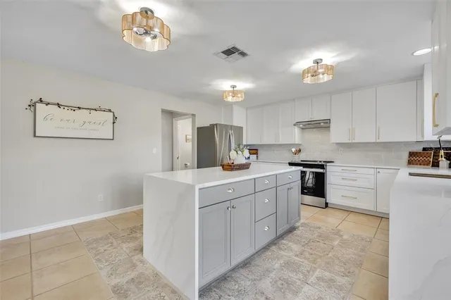 a kitchen with cabinets a sink and appliances