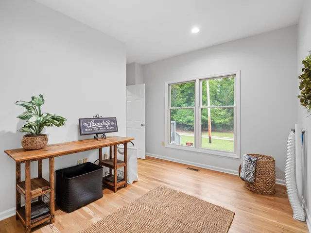 a bathroom with a tub a window and a shower