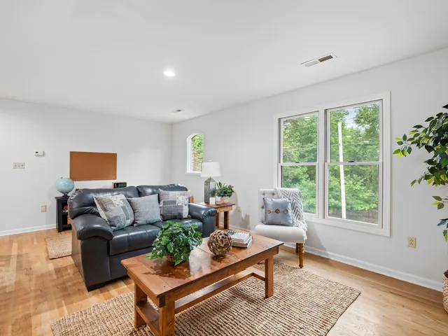 a living room with furniture pool table and a window