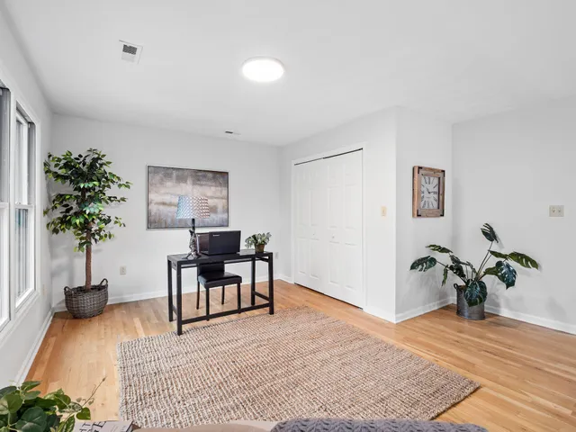 a view of a house with a yard and large tree