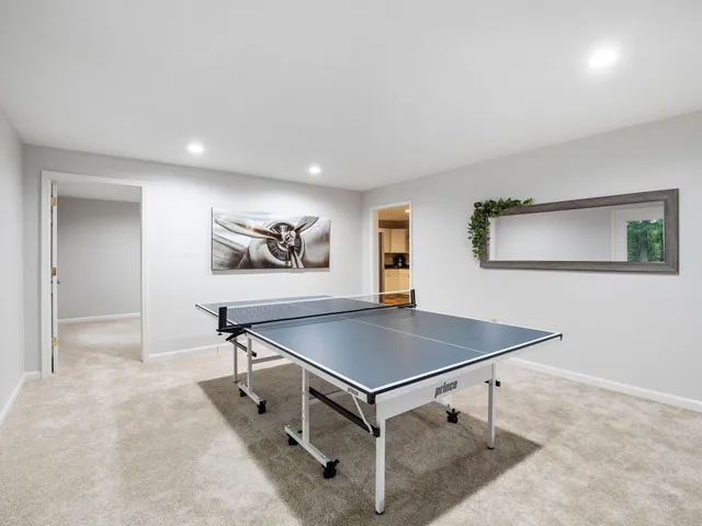 an aerial view of a houses with a yard and lake view