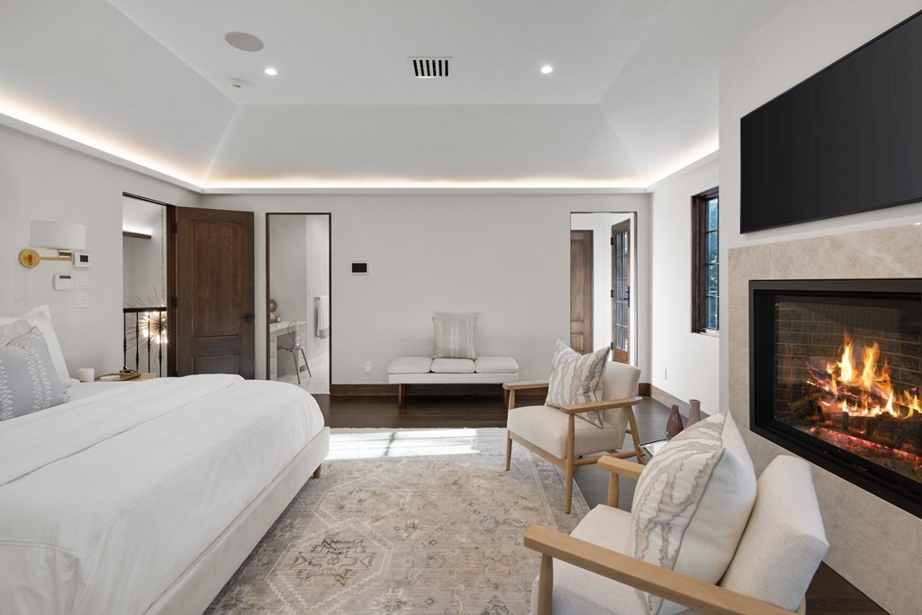 17 Bridle Pth Path Weston, MA 02493 - Photo 22 of 42 a spacious bedroom with a bed and a flat screen tv