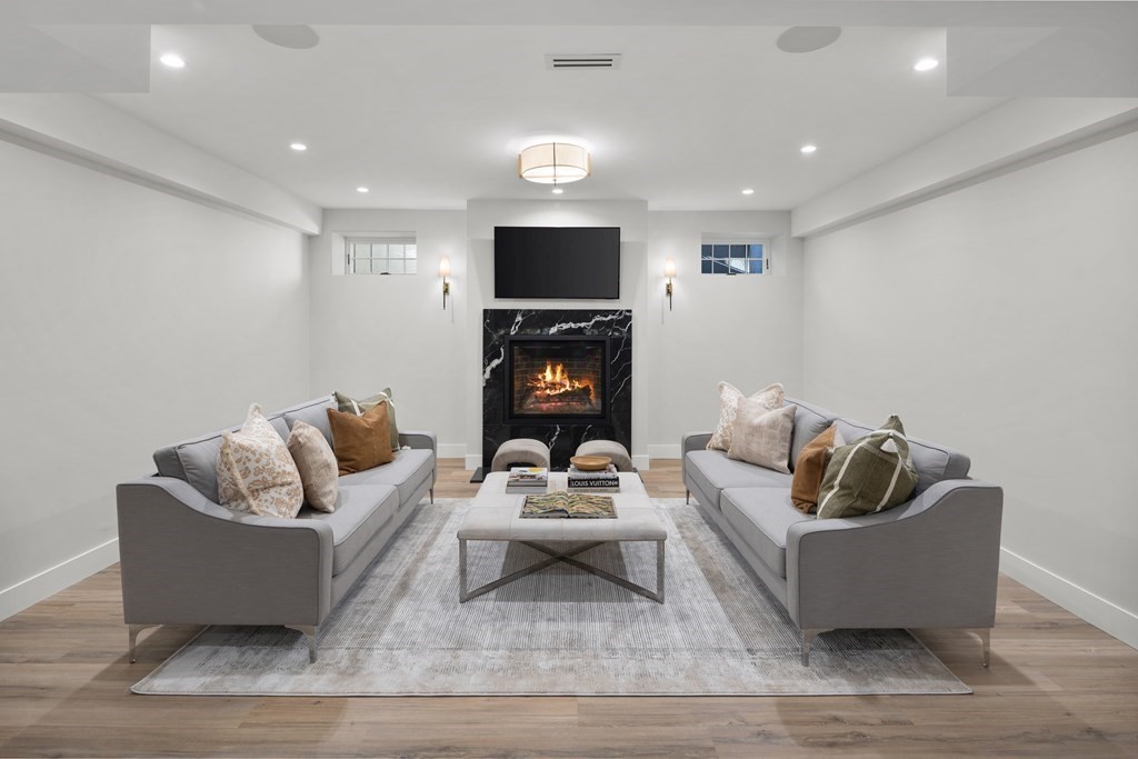 17 Bridle Pth Path Weston, MA 02493 - Photo 28 of 42 a living room with furniture and a flat screen tv
