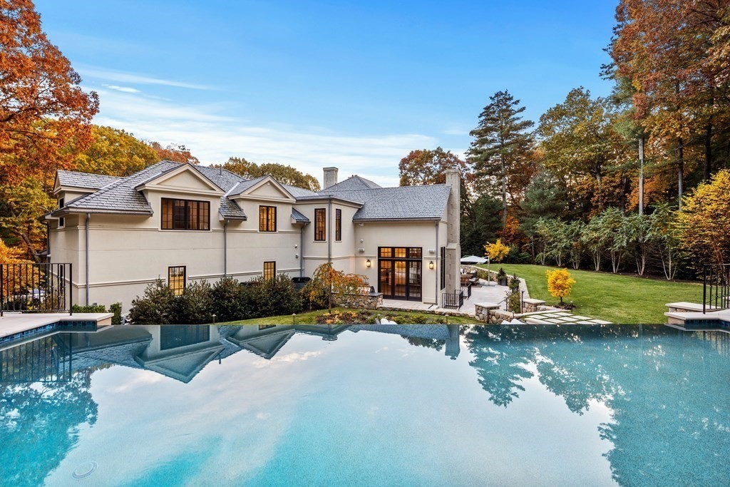 17 Bridle Pth Path Weston, MA 02493 - Photo 37 of 42 a front view of a house with swimming pool and a yard