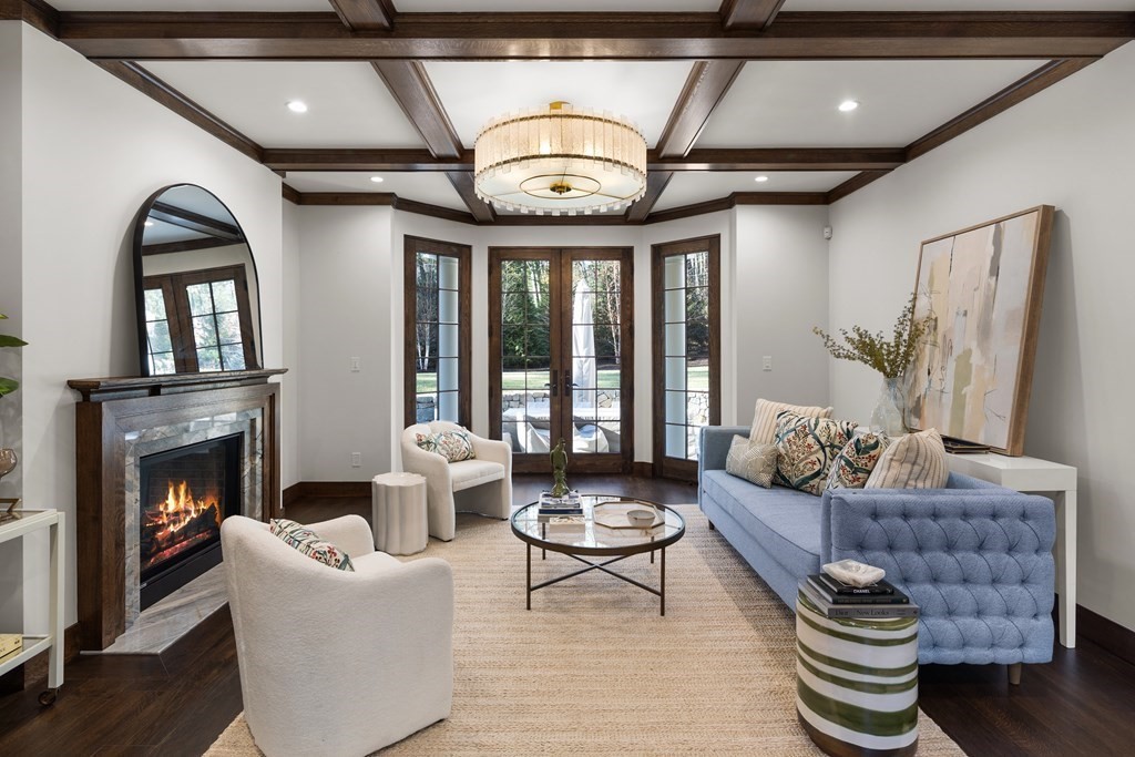 17 Bridle Pth Path Weston, MA 02493 - Photo 6 of 42 a living room with furniture a chandelier and a fireplace