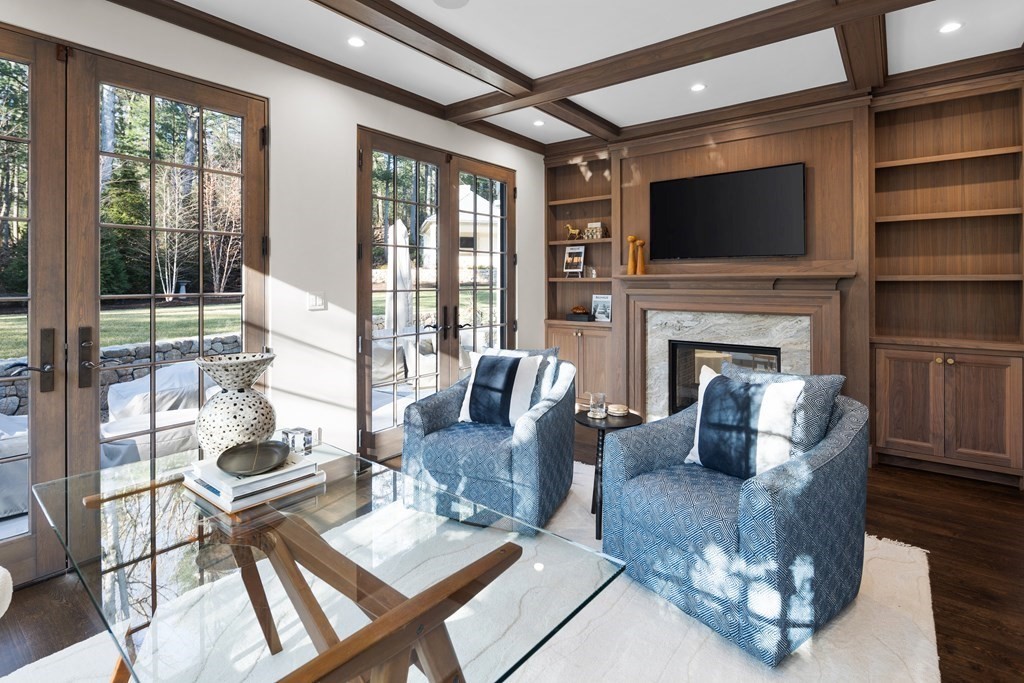 17 Bridle Pth Path Weston, MA 02493 - Photo 7 of 42 a living room with furniture a flat screen tv and a fireplace