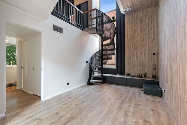 a view of an entryway with wooden floor and stairs