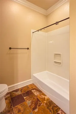 an empty room with a window and a ceiling fan