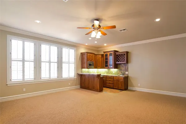 a kitchen with granite countertop a sink and cabinets