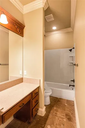 a bathroom with a granite countertop tub sink and mirror