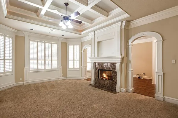 a view of a livingroom with a fireplace wooden floor and fire place