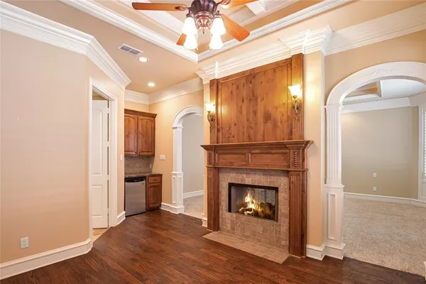 a utility room with wooden floor washer and dryer