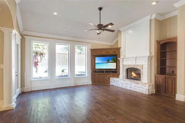 a view of an empty room with a fireplace and a window