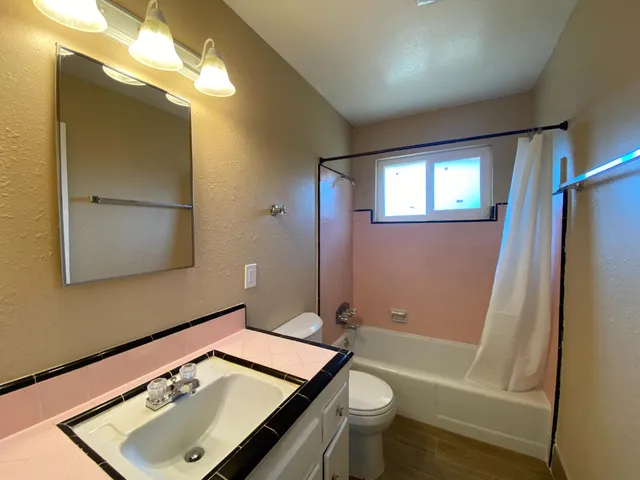 a bathroom with a sink toilet and shower