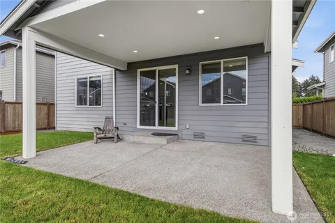 a front view of a house with a yard and a garage