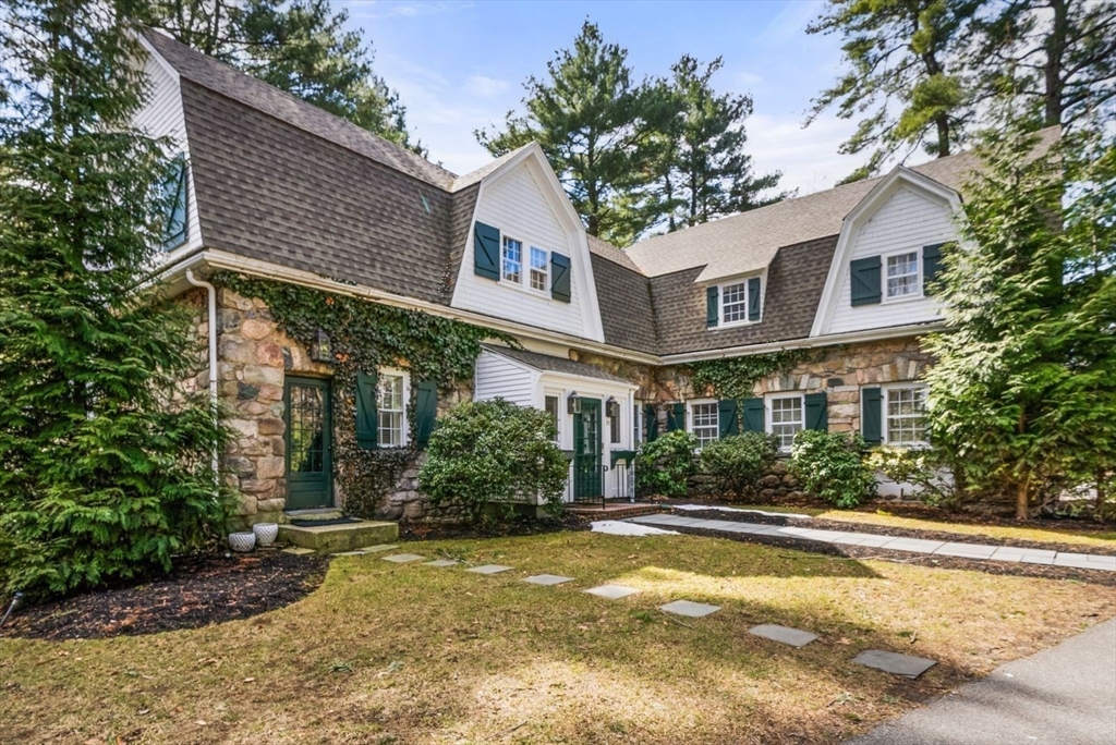 a front view of a house with a yard and outdoor seating