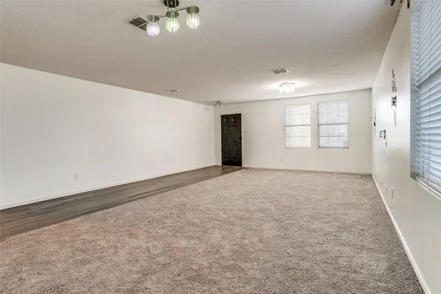 an empty room with a empty space and windows