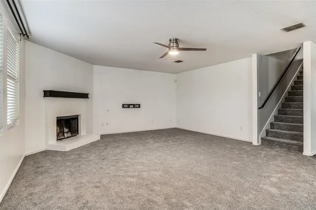 a view of an empty room with a fireplace
