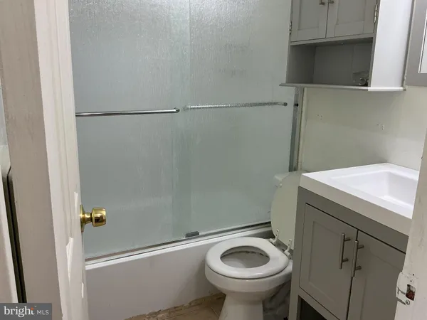 a bathroom with a glass shower door