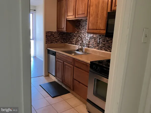 a kitchen with granite countertop a sink and a stove