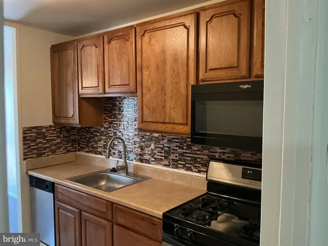 a kitchen with a refrigerator and a stove